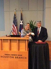 Two professionals standing near a podium