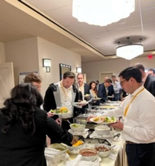 People crowding a buffet table