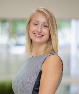 Smiling woman in business attire.