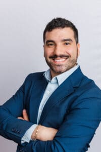 Smiling businessman with arms crossed.