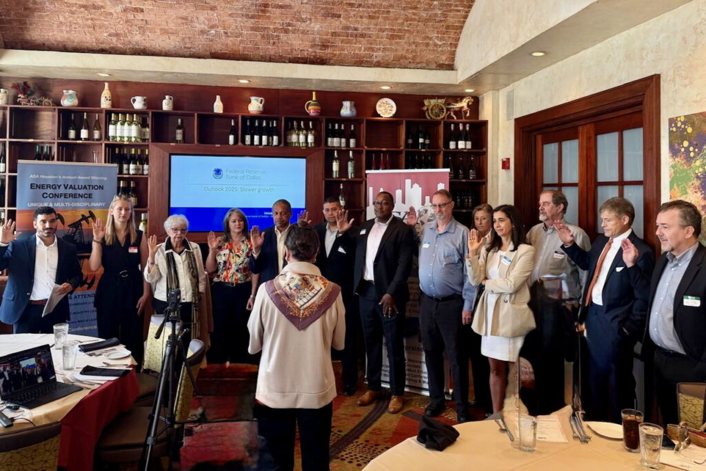 Group of people standing in a room.
