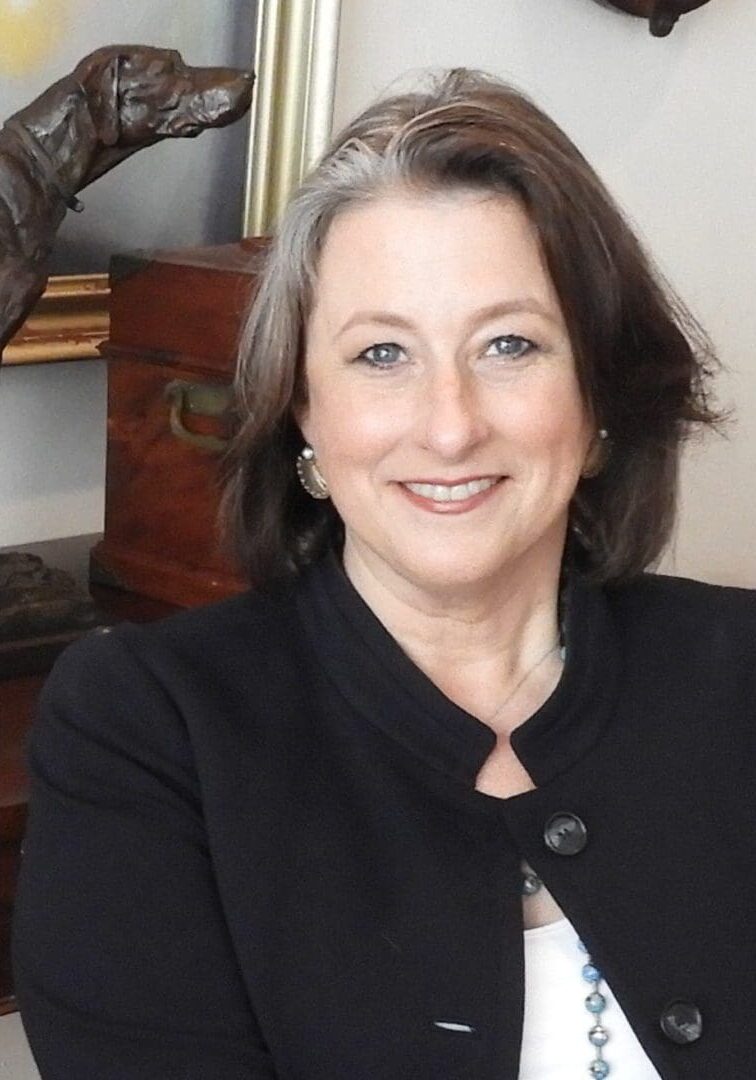 Barbara Headshot 2019 Image of a woman with a dog statue in the background